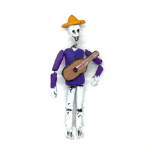 Load image into Gallery viewer, Mexican handmade traditional folk-art calaca skeleton musician with instrument. Can be hung or bends to display 